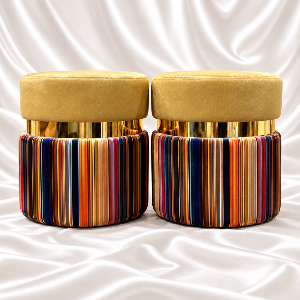 Pair of luxury mustard velvet ottoman stools with polished gold bands and vibrant multicolor striped bases