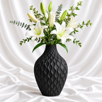 Matte black textured decorative flower vase with raised wave design and white lilies
