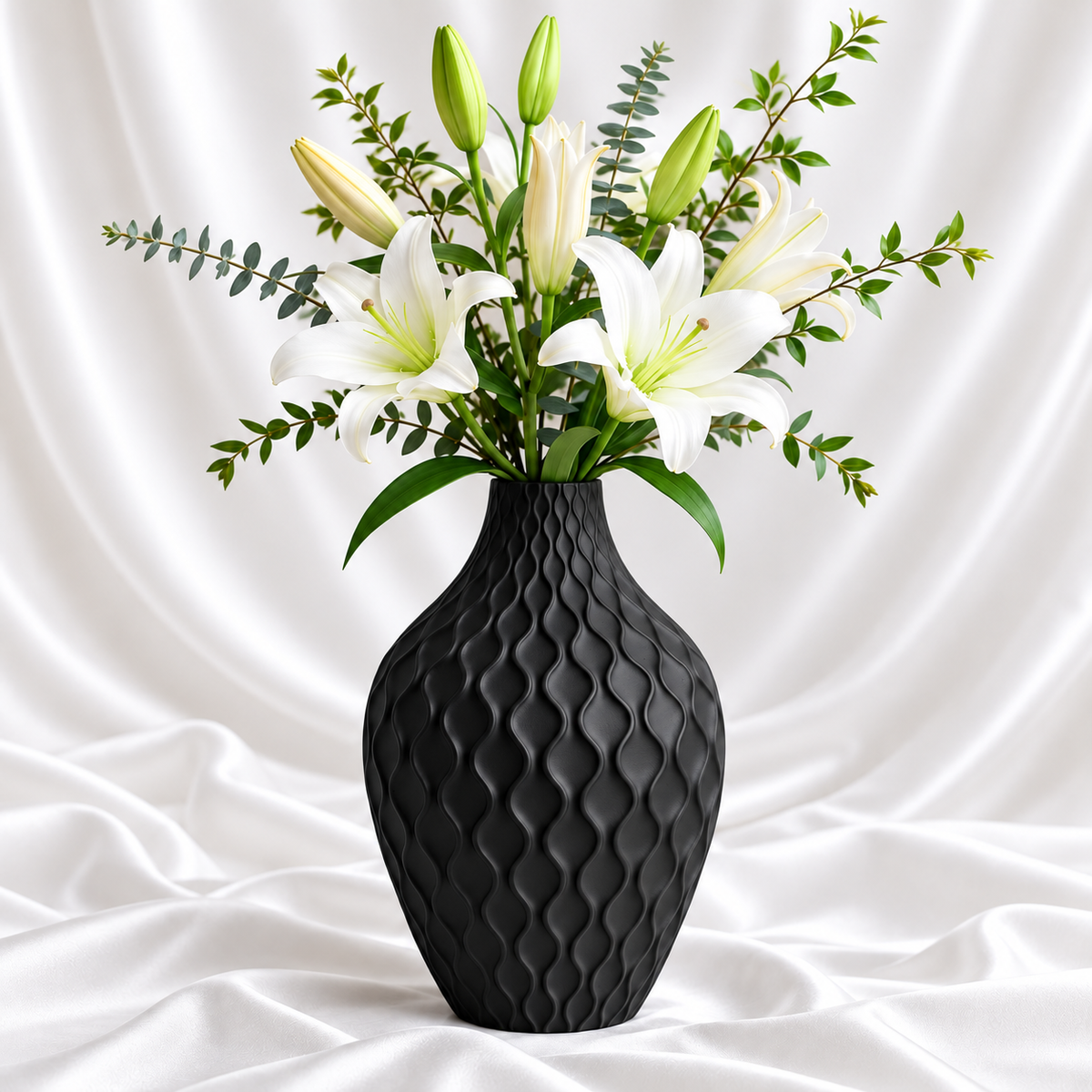 Matte black textured decorative flower vase with raised wave design and white lilies