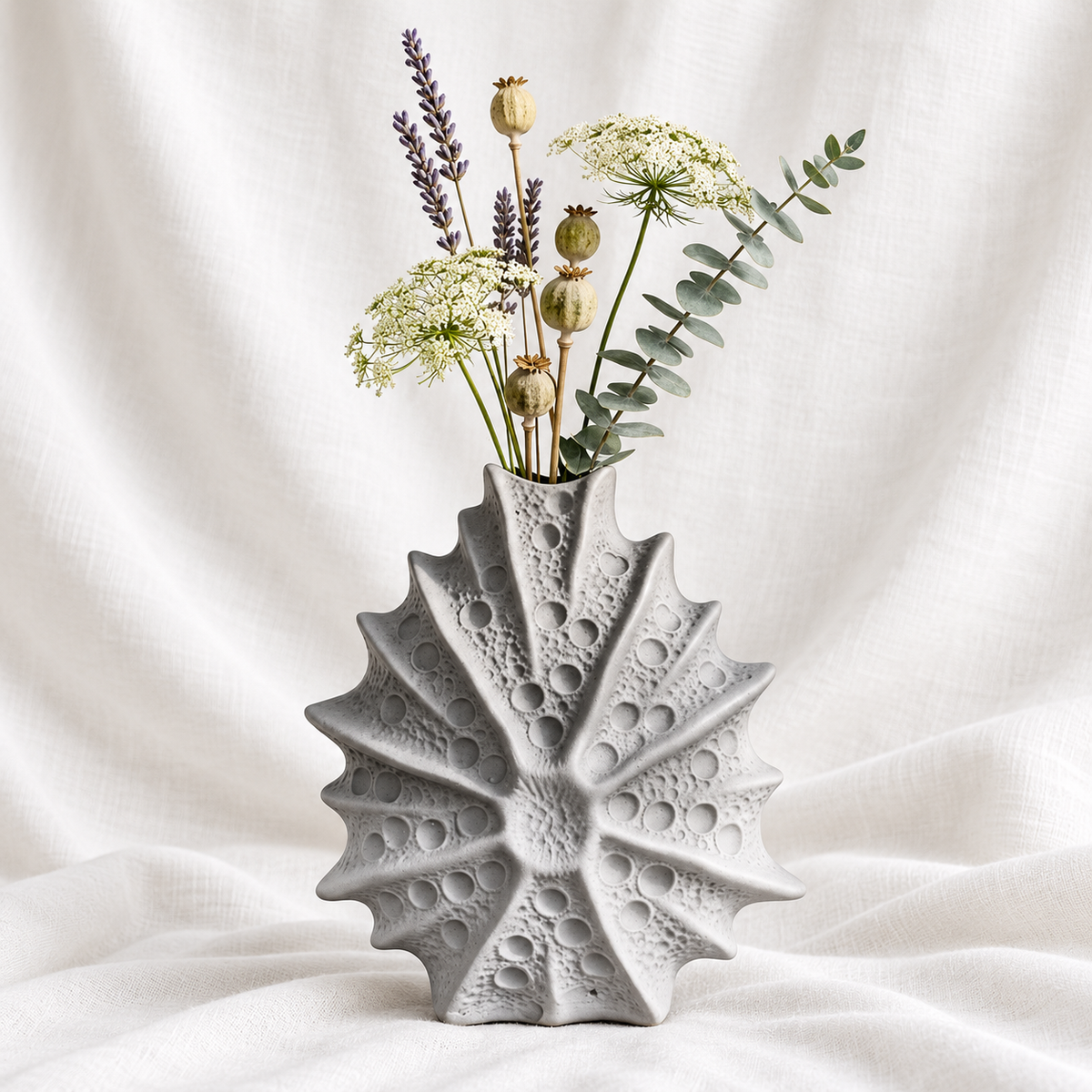 White sculptural starburst decorative vase with textured circular detailing for modern living room, console table, shelf and tabletop decor.