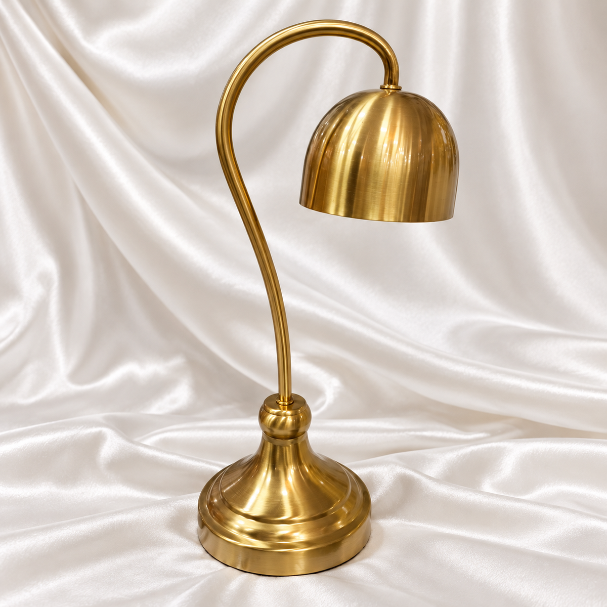 Modern golden table lamp with dome shade, curved stand and premium decorative finish.