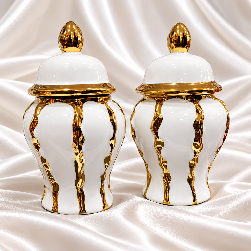 Set of two matching white decorative jars with lids and gold-tone accents