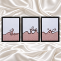 Three black-framed Islamic calligraphy artworks with pale backgrounds, dusty pink textured lower sections and flowing dark lettering on white satin fabric.