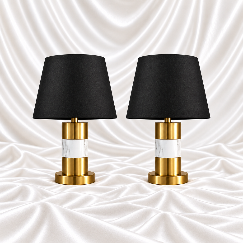 Pair of 28 inch luxury black and gold marble table lamps with black shades displayed on a white satin fabric background.