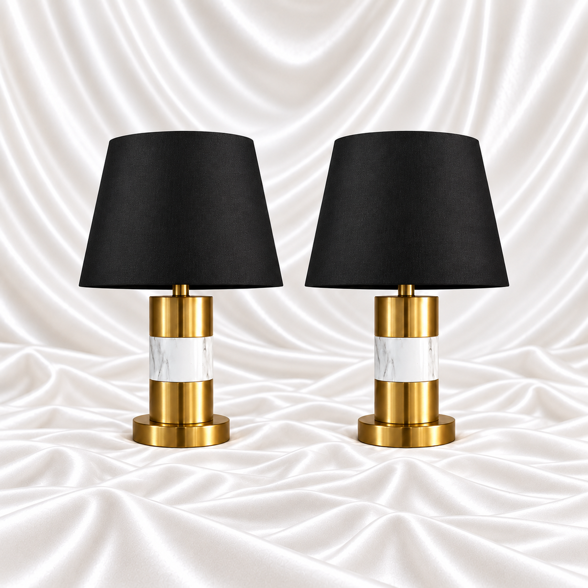 Pair of 28 inch luxury black and gold marble table lamps with black shades displayed on a white satin fabric background.