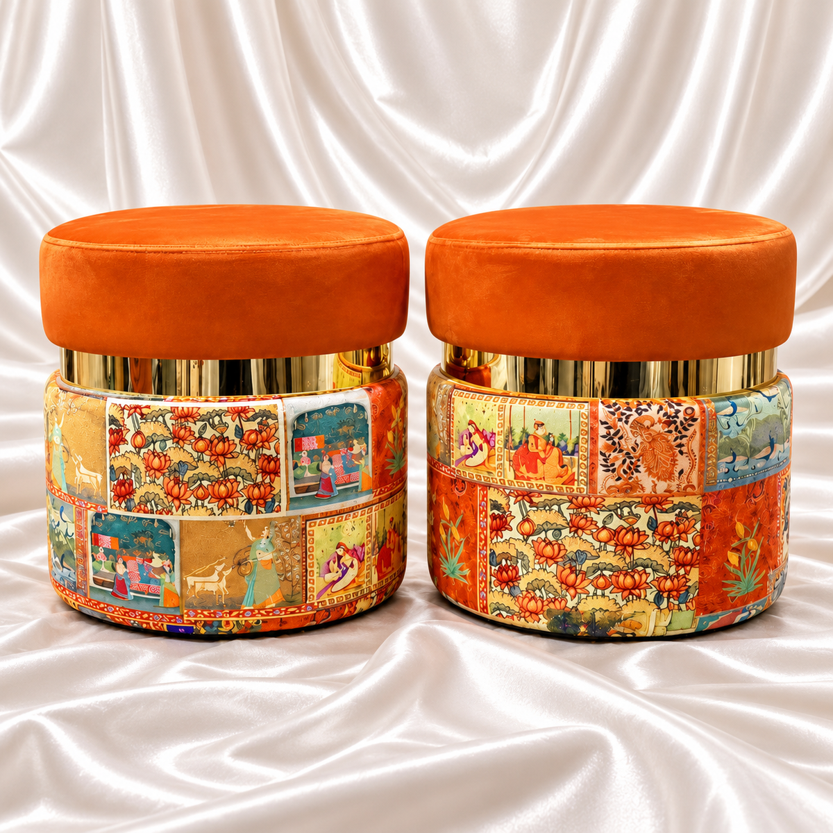 Pair of orange ottoman stools with gold-tone bands and multicolour patchwork bases on white satin fabric.